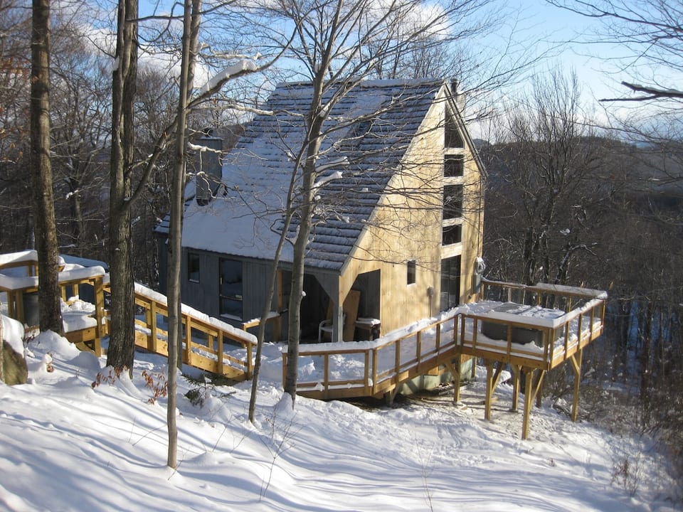 Exterior view of House. Stairs from Driveway and Deck.