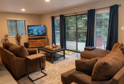Lounge on the loveseat & couch with a 65" 4K TV and view of the pines off the balcony.
(This photo shows a 55" TV which has since been upgraded!)