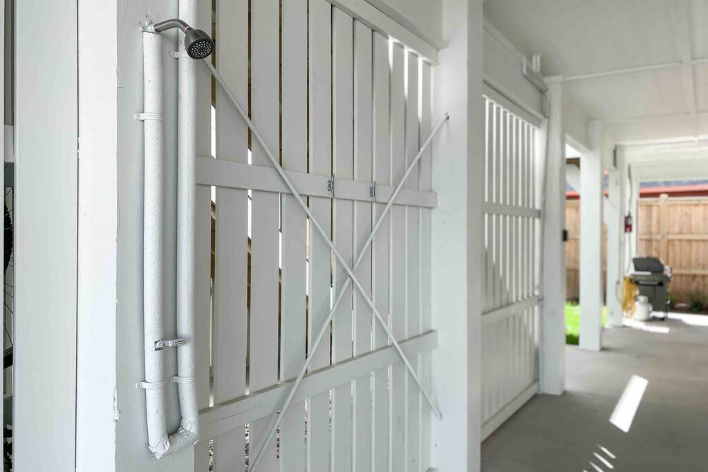 Under home by parking pad is outdoor shower and hooks to rinse off before entering home.