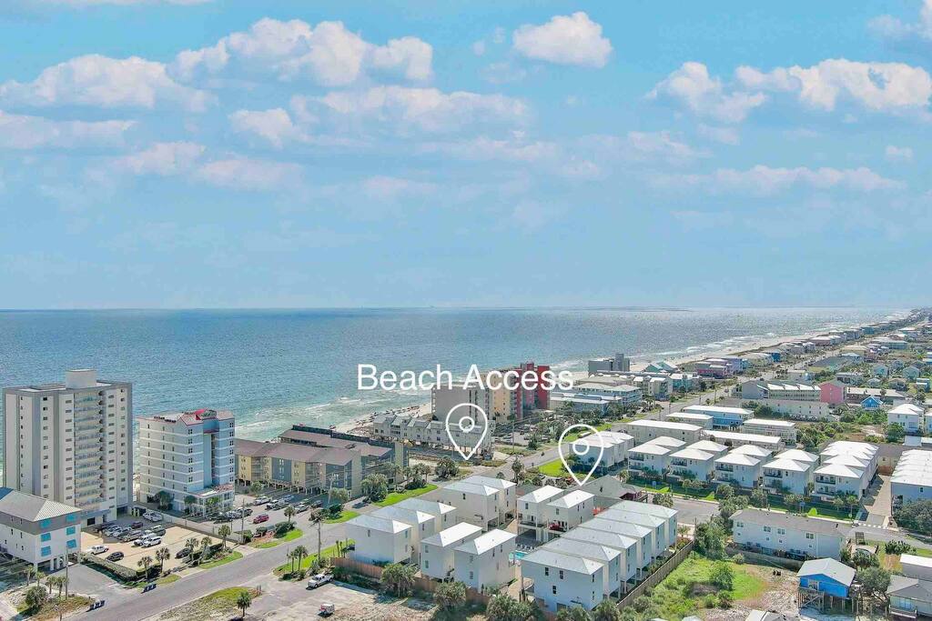 Brand new cottage is 100 feet from two different beach access points.  Shown in this photo is the public beach access which has a wooden walkway and shower and bathrooms.  Also, additional public parking
