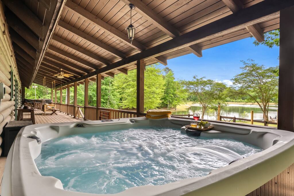 Hot tub over looking the private lake sits under cover roof for privacy and enjoyment while relaxing away your stress and worries.  The hot tub is  perfect for 4-6 adults to enjoy. 