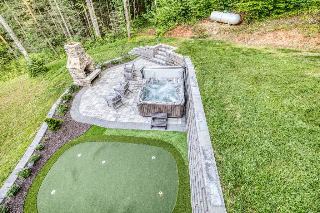This is where the magic happens!!! It’s the ultimate outdoor space with brand new paver stone patio complete with fireplace and hot tub. Soak in the tub or practice your golf put, this area is open and easily accessible from terrace level