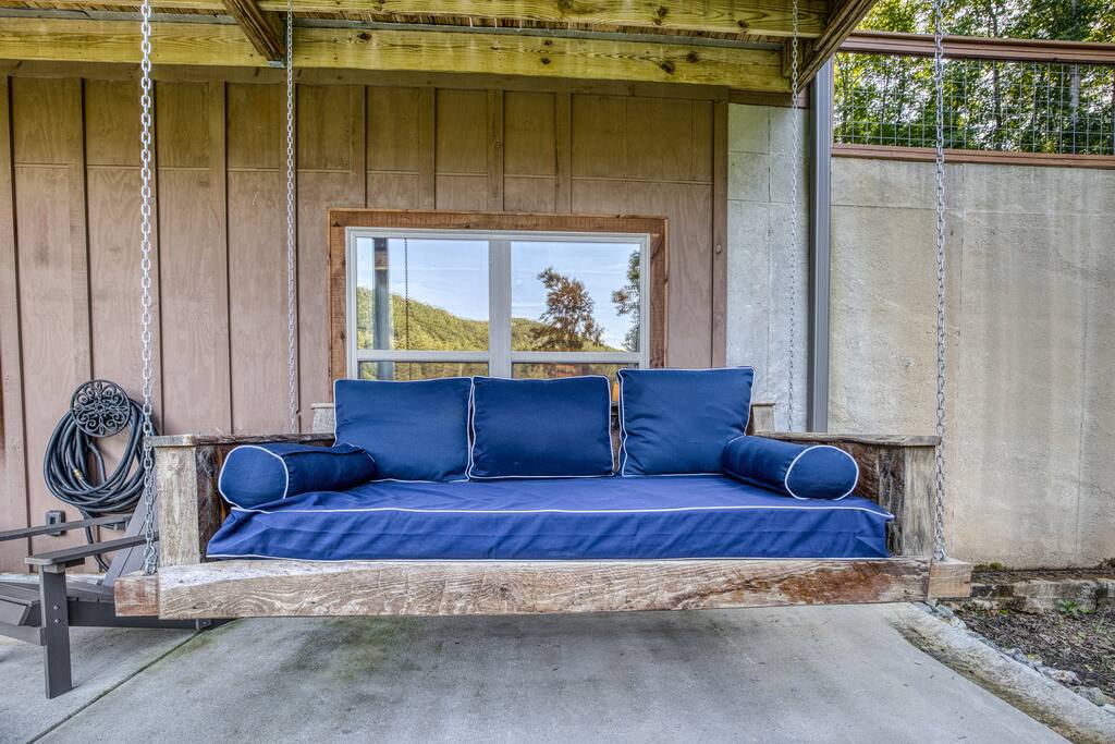 Take a nap or snuggle up and read a book while swinging on the fabulous rustic  wooden swing bed. 