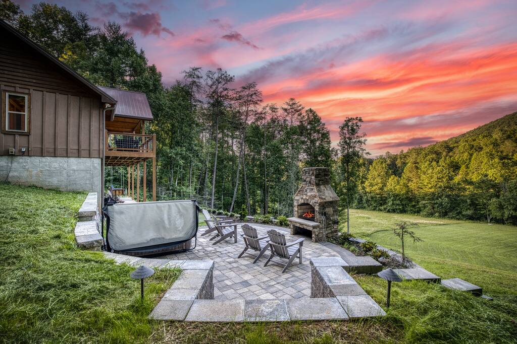 New May 2025! Paver stone patio with fireplace, hot tub and large putting green opens up to spacious 3 acres of green grass. 