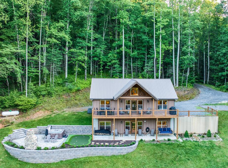 Brand new outdoor entertaining space with mini golf putting green, hot tub, swing bed, fireplace and covered porch. Enjoy dining outside after cooking dinner in gas grill. View from every bedroom 