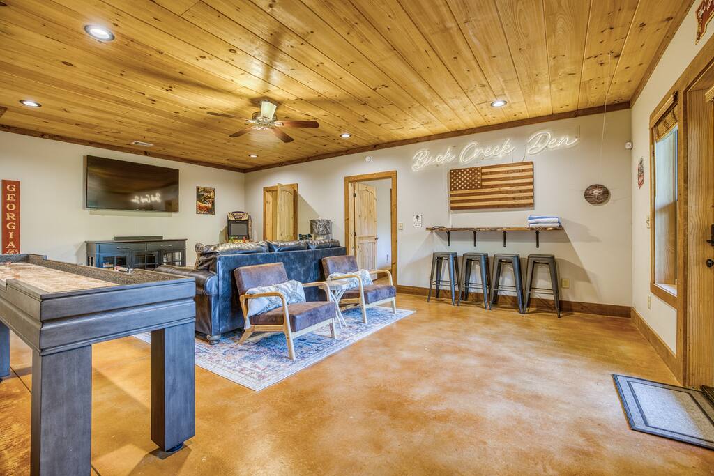 Gorgeous stained concrete floors on terrace level continue the modern rustic vibe. Games for everyone this space has two sleeping rooms (bunk room and separate king bedroom). 