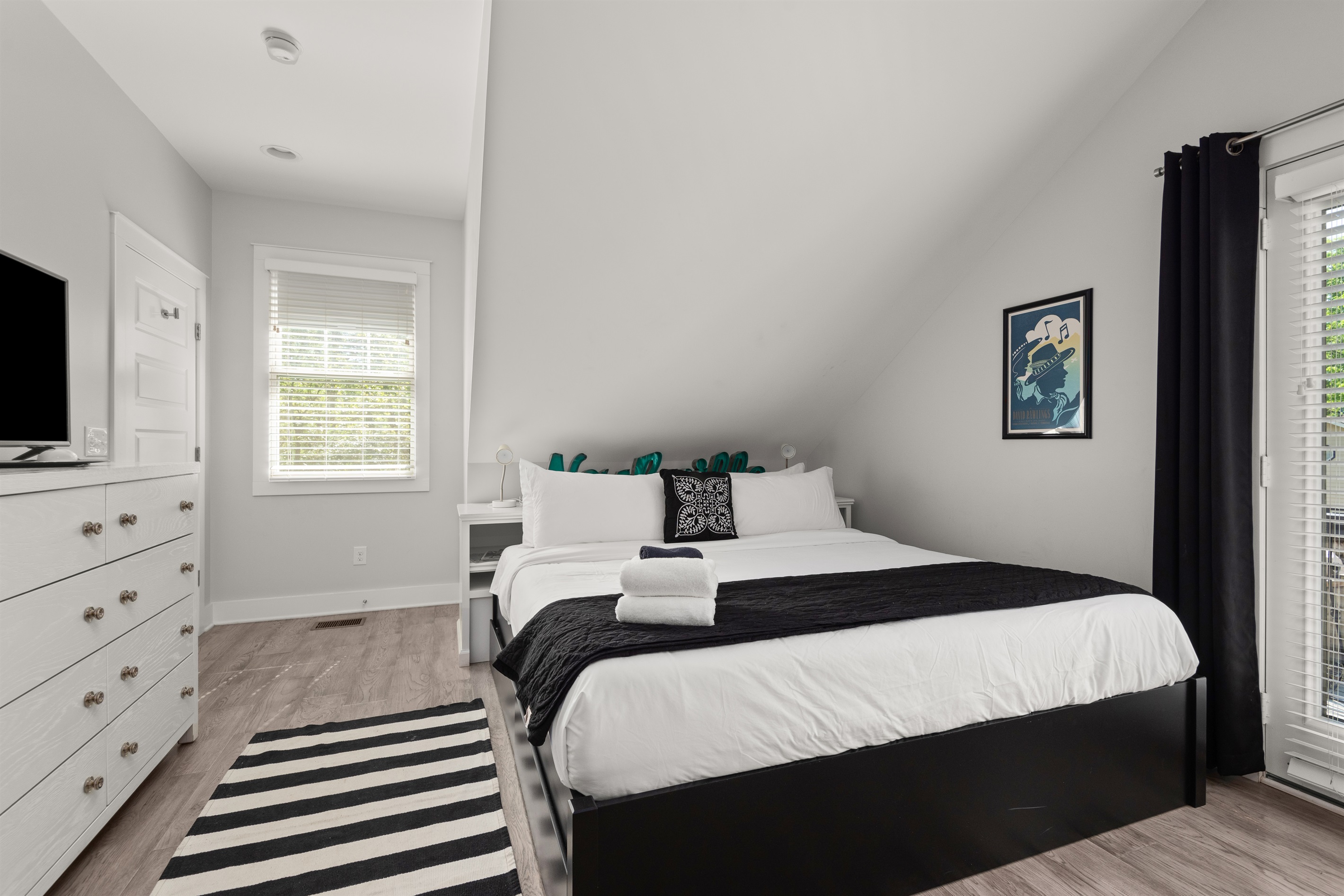 Bedroom has a king bed, private balcony, and flat screen TV