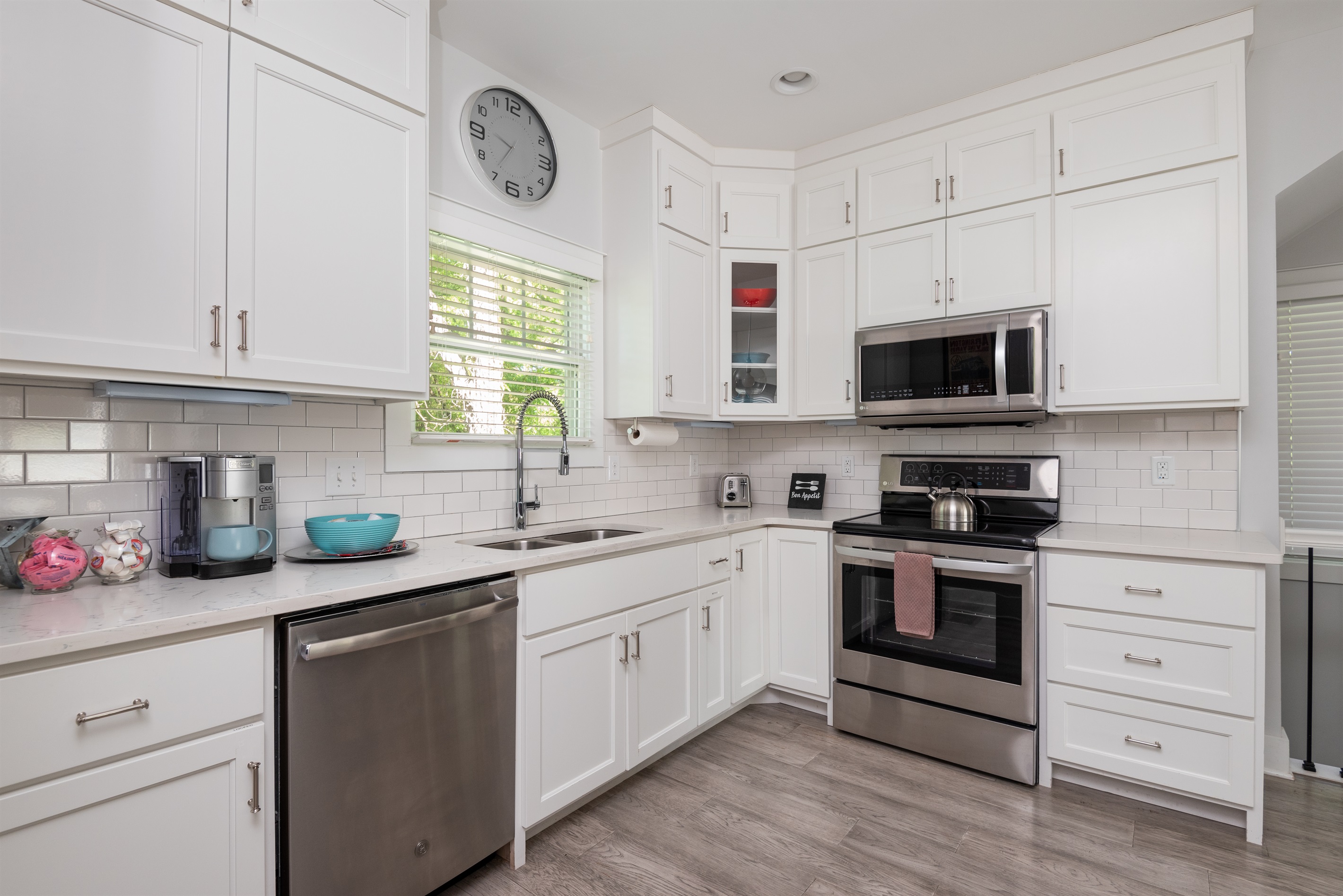 Bright and inviting kitchen, fully stocked for you to prepare and enjoy a meal.