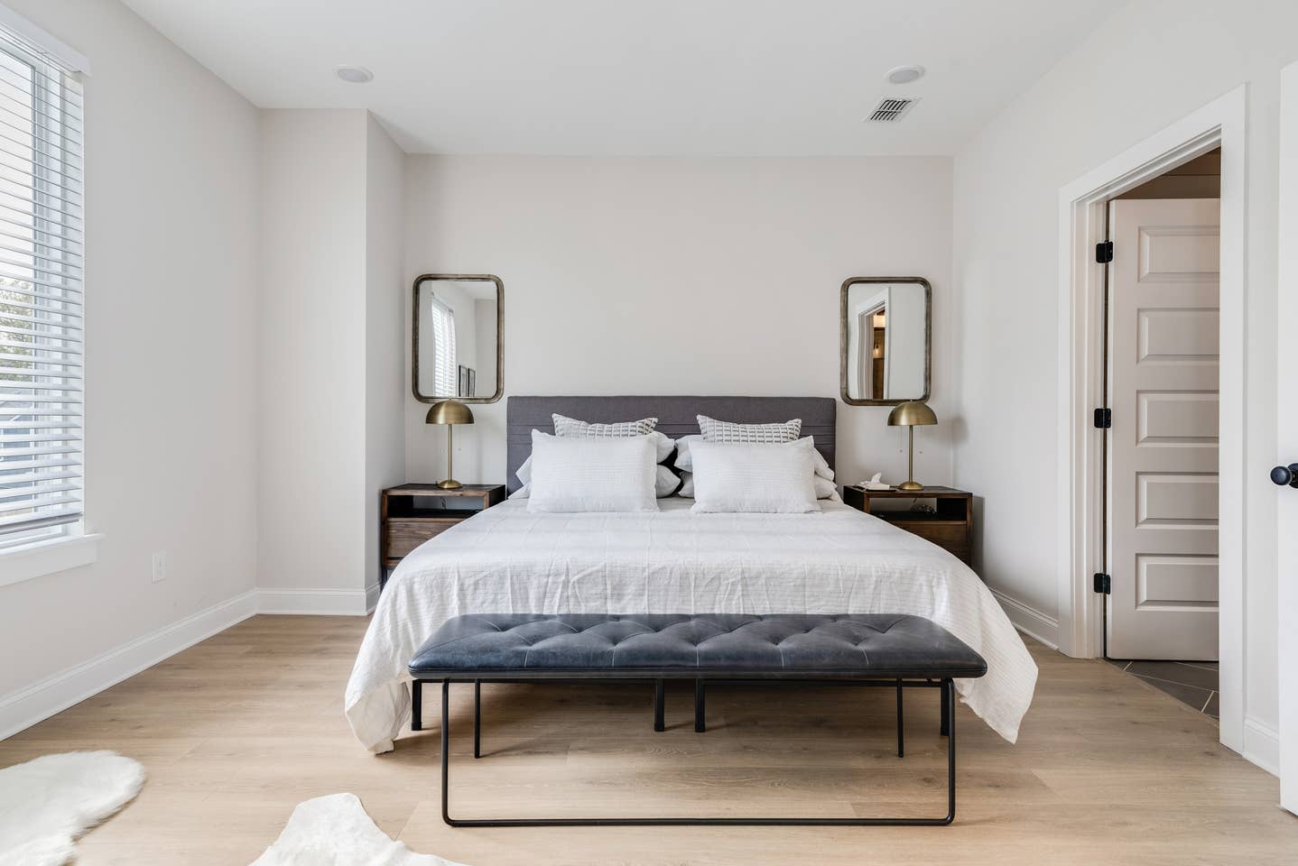 Spacious primary suite has a memory foam king bed, massive walk-in shower with double vanities in the bathroom, and a 55-inch TV.