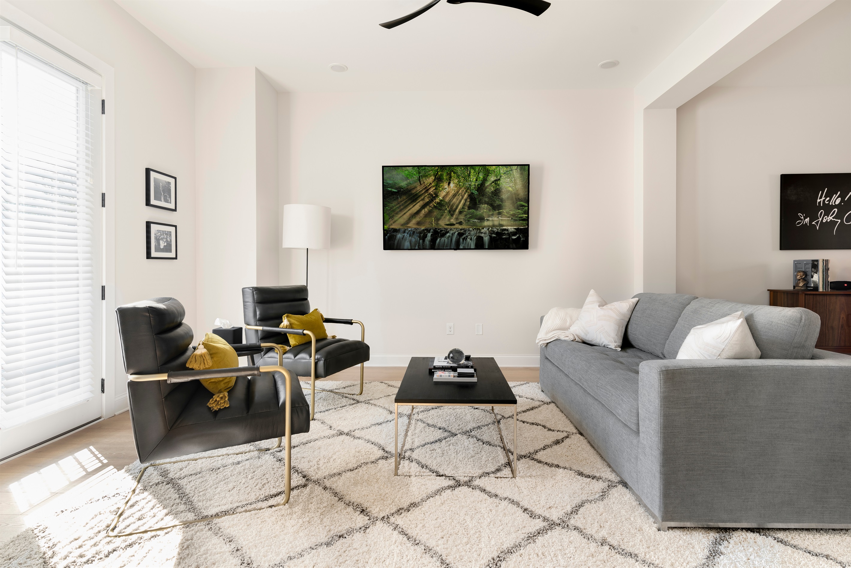 Mid-century modern furnishings and an enormous 70-inch TV in the living room