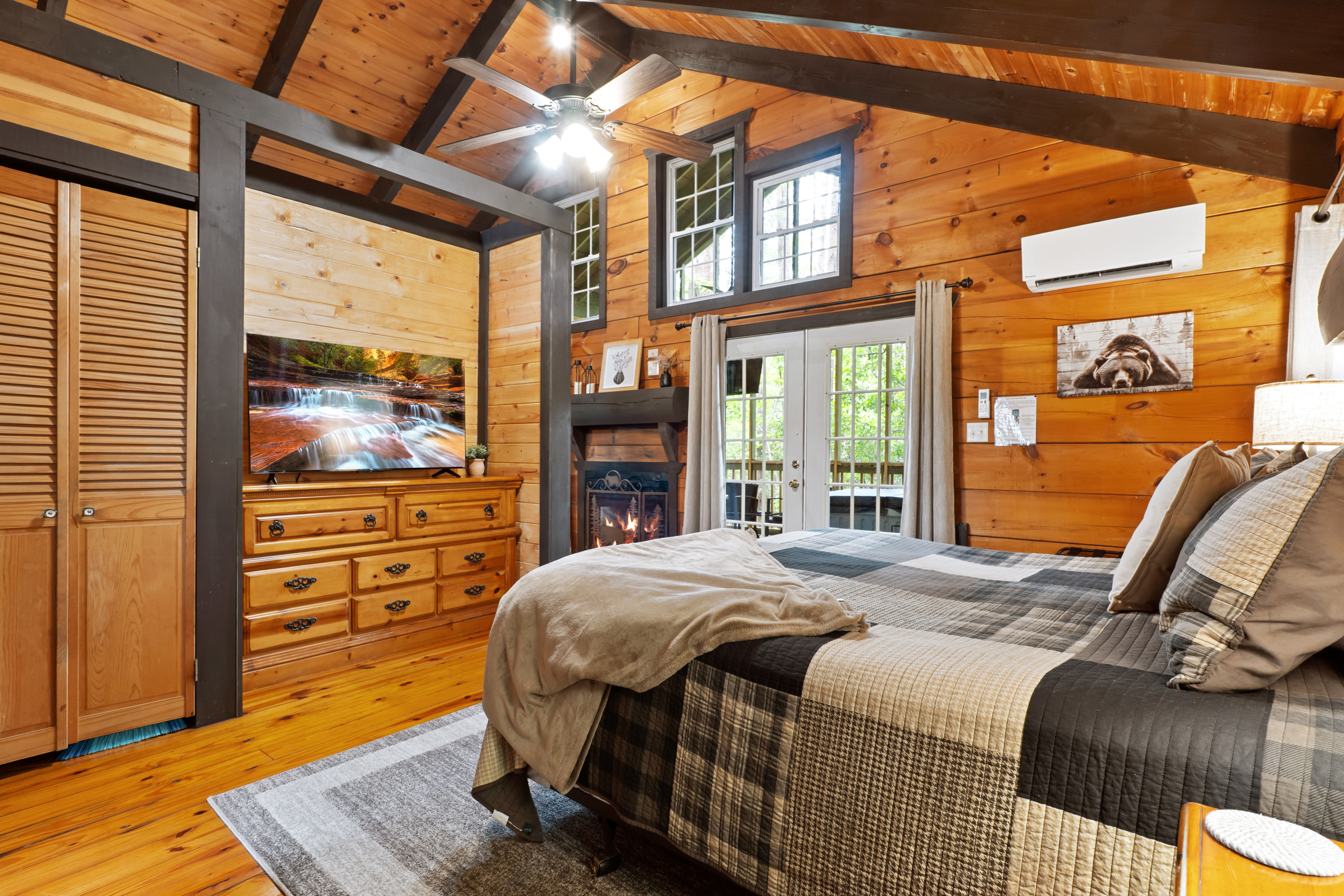 Sleep in comfort with a view of the trees. The cozy king bed, crackling fireplace, and access to the screened porch create the perfect romantic retreat.