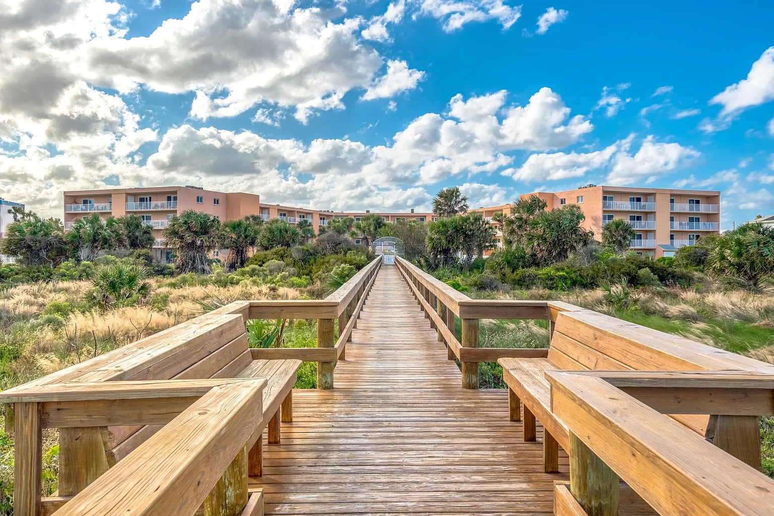Coastal Dreams condo viewed from beach with pool and boardwalk access