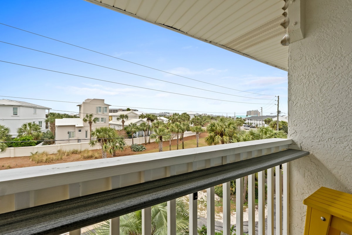 Start your day with a peaceful view of palm-lined streets and coastal homes.
