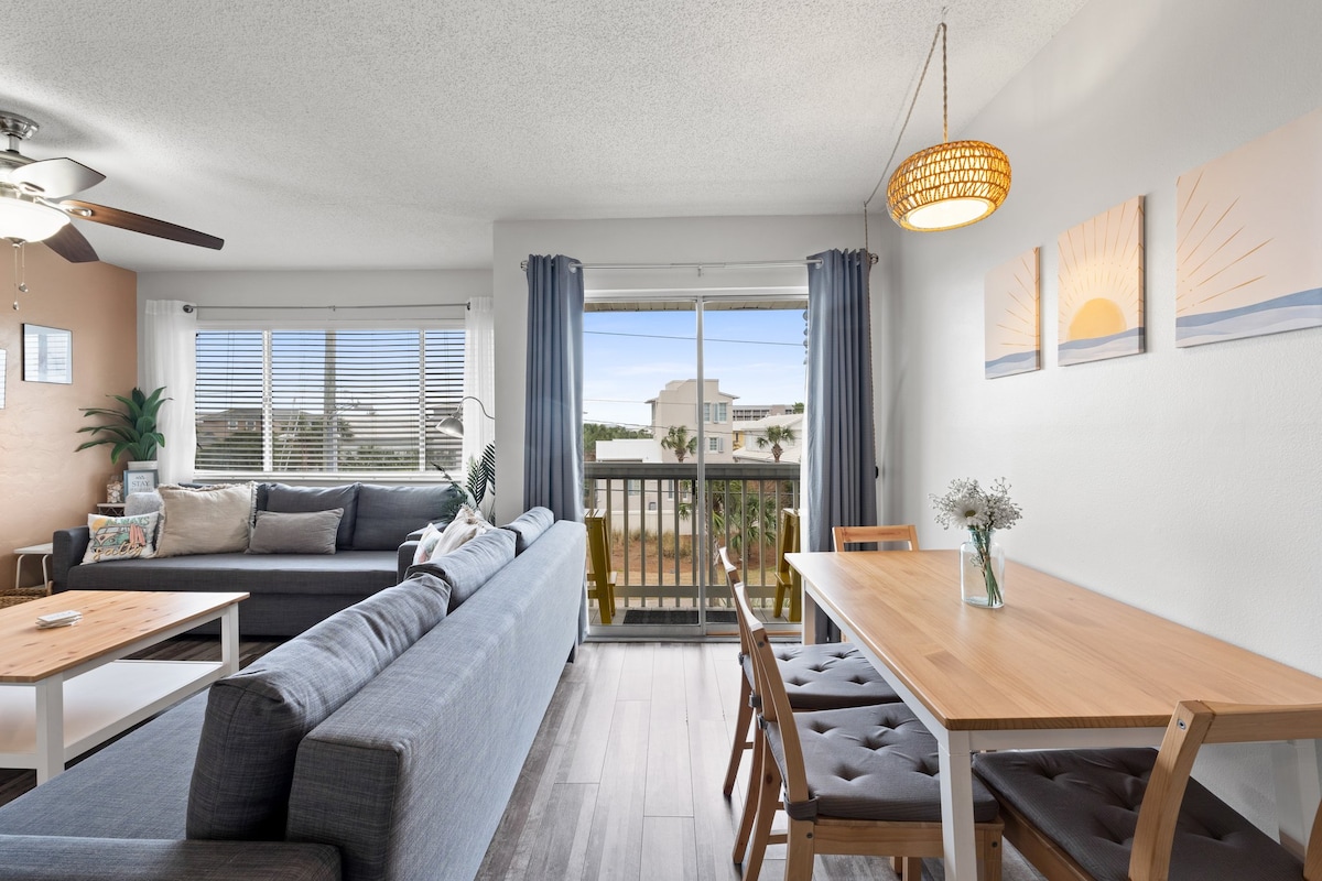 Open-concept dining and living areas flow seamlessly to the balcony for effortless indoor-outdoor living. 3 Beaches + 2 Free Bikes - Stay at Always Salty!