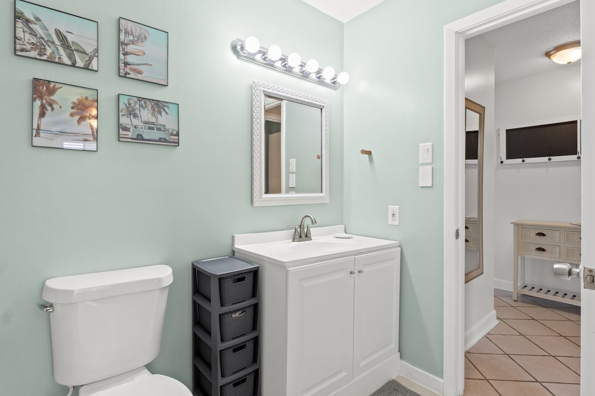 Bright and clean bathroom with spacious vanity and easy access to the hallway.