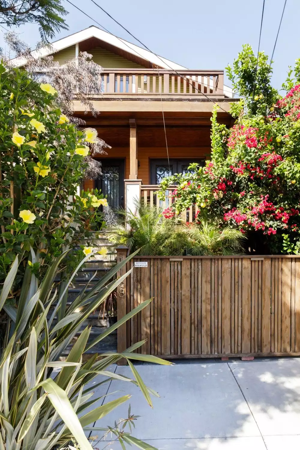 Natural California Gold Stone Staircase; Reclaimed wood elements; Tall wrought-iron gates; Resista German green exterior,  Lush greenery - California Craftsman — Urban Oasis - Emeryville