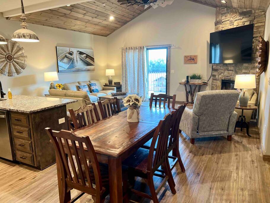 Plenty of seating in the living room along with a great view of the pool and lake on the deck. There are 6 chairs at the dining room table. - 7 BR Resort Cabin w/ Hot Tub & Boat Slip TR Lake! - Indian Point