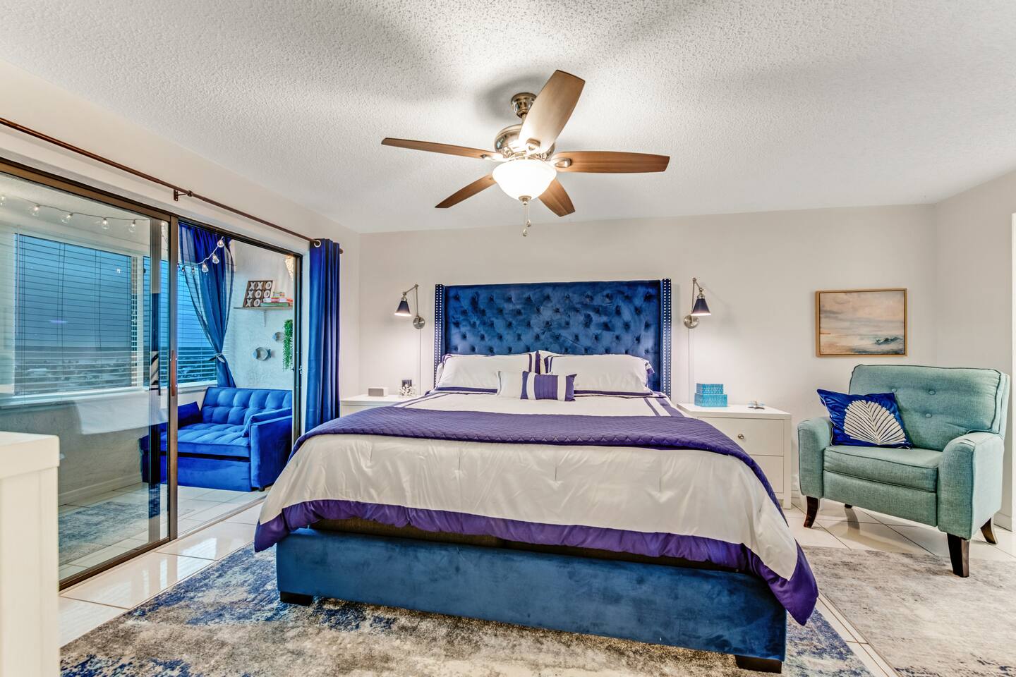 King sized bed  and recliner in bedroom with nightstands, dresser, 55" Smart TV and desk. Ensuite bathroom and walk in closet.