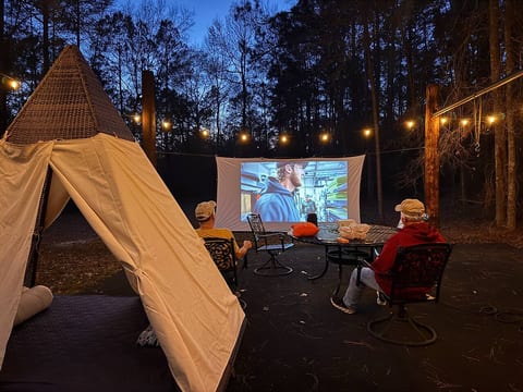 All bookings may enjoy our standard dvd projector free of charge. Our Movies Under the Stars experience is an upgrade that includes our new high resolution, streaming and Bluetooth projector and premium snacks and drinks with props.