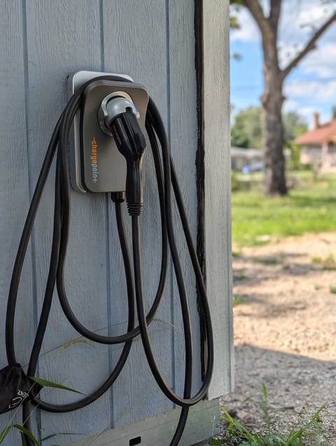 Level 2 charger available for guest use, located on the side of the tool shed at the end of the gravel driveway.