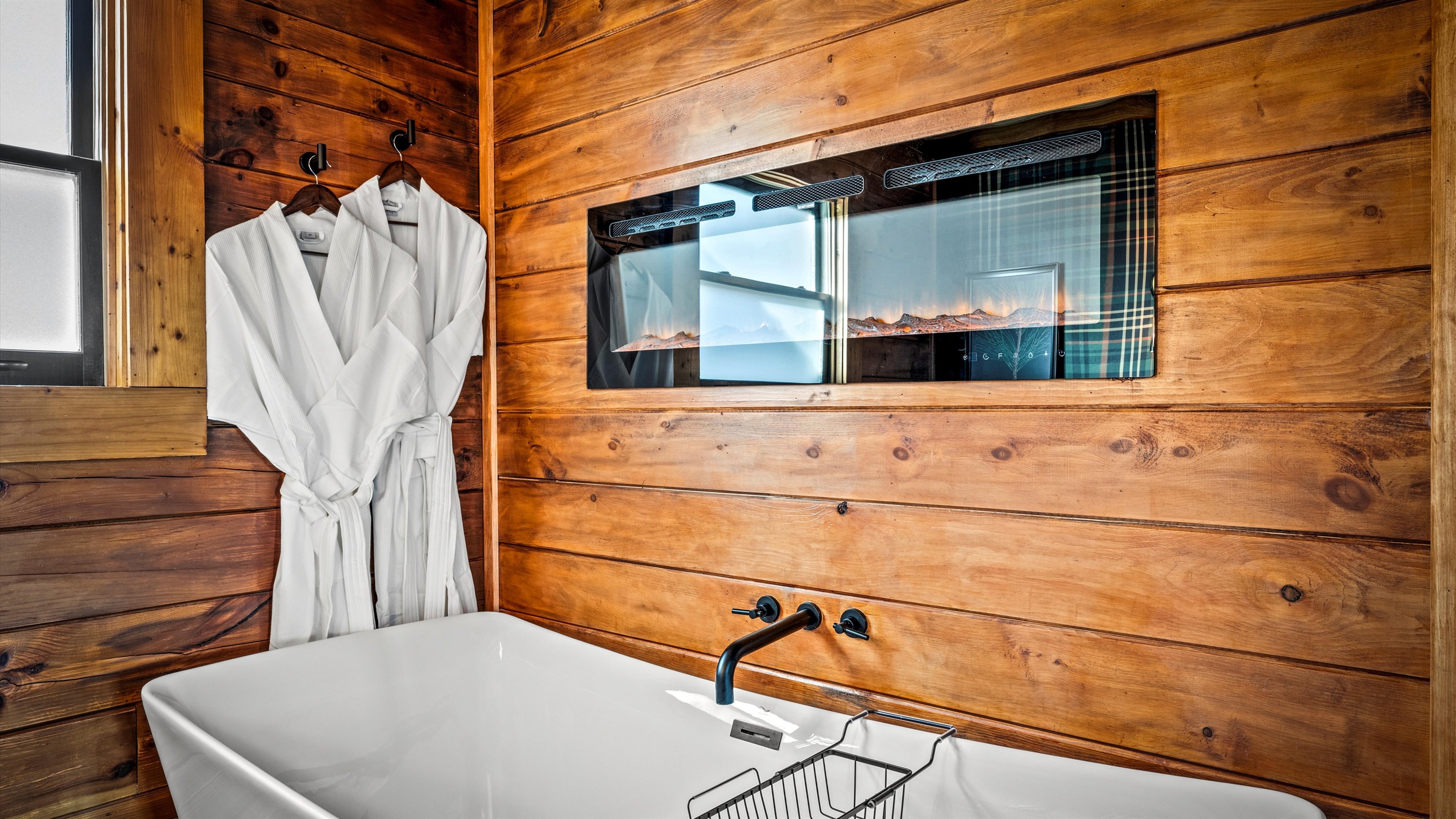 Indulge in a soothing soak in the freestanding tub beside a cozy fireplace, with plush robes waiting just for you. The spacious bathroom offers ample counter space and includes bath towels, washcloths, hand towels, and extra towels for the hot tub.