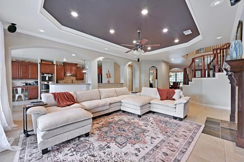 Cozy living room with open concept to the kitchen and breakfast room. Ceiling fan, dimable lighting, and wired surround sound. Gas log fireplace.