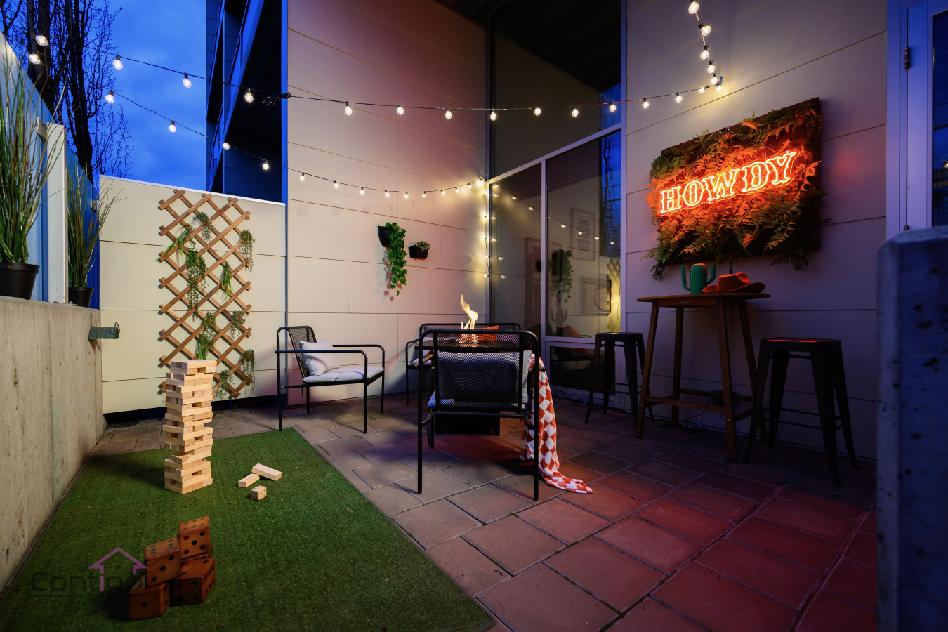 Howdy! Welcome to your cozy outdoor retreat, complete with a charming neon glow. Fire table, BBQ, outdoor games, outdoor lighting, you name it!