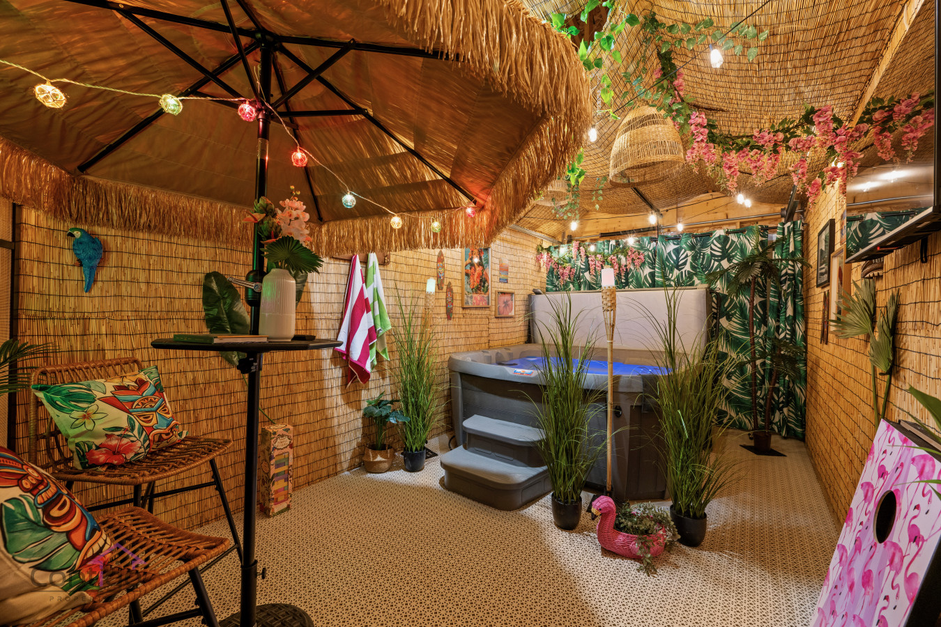 Escape to your own tropical oasis! Relax and unwind in the shared hot tub surrounded by lush greenery and tiki vibes.