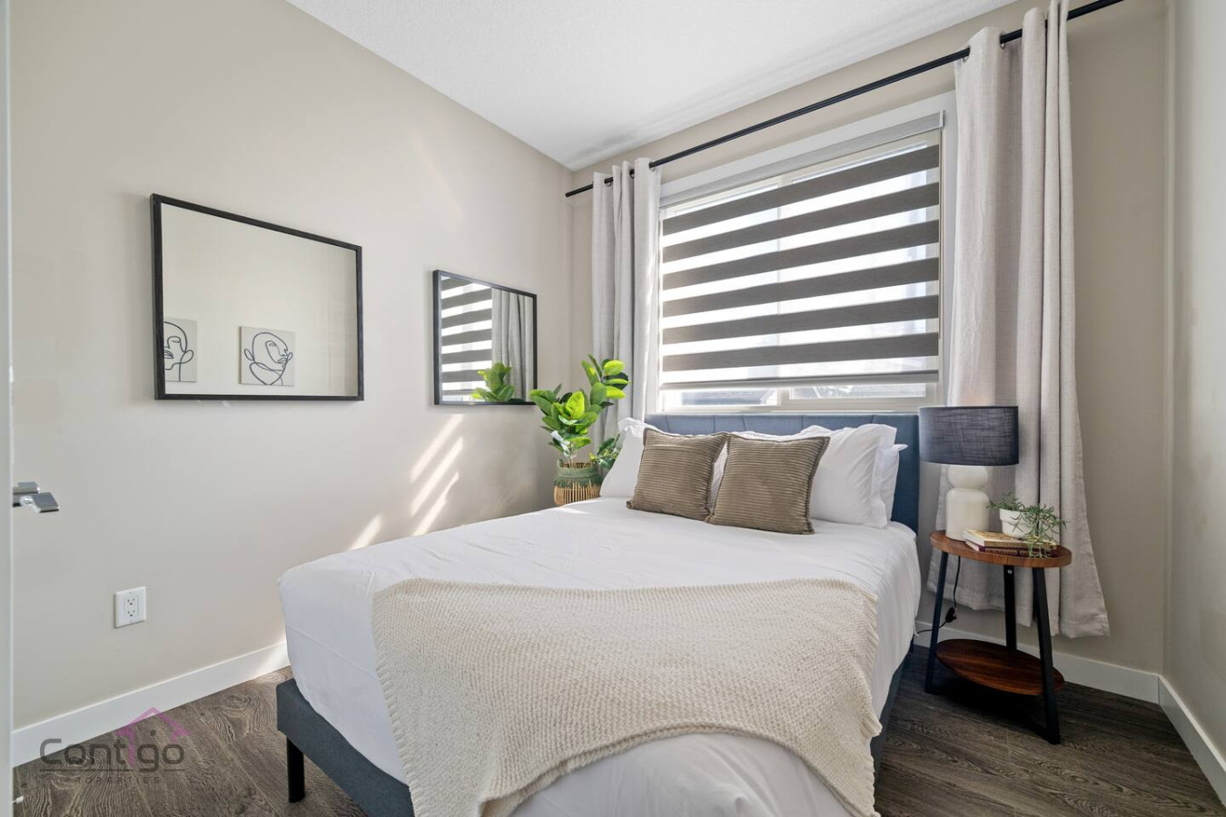 Relax & Recharge in our cozy queen bedroom, featuring blackout curtains and a bedside lamp for the perfect wind-down vibe.