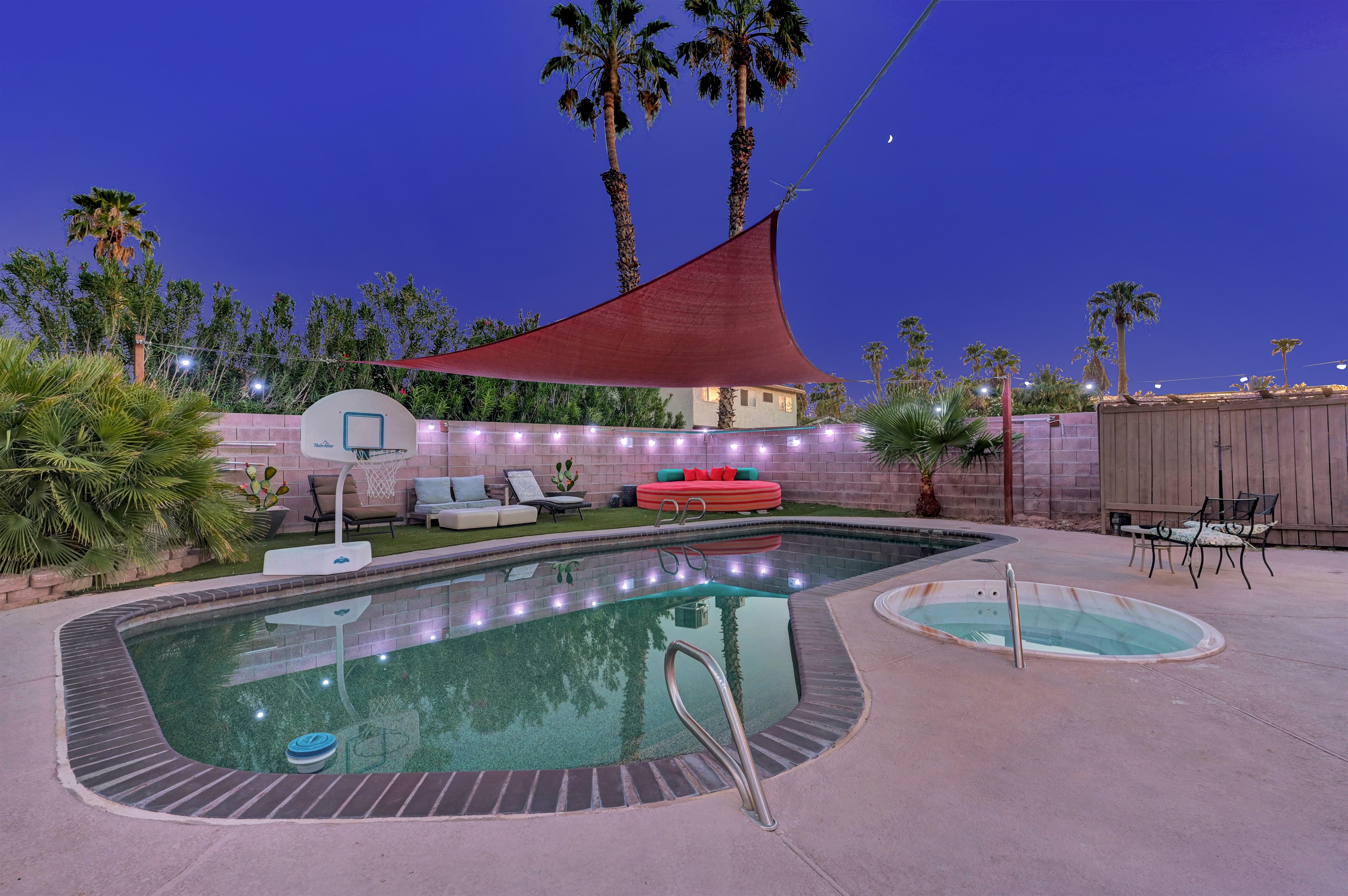 Shaded Pebble tec pool, pool basketball, loungers, and day bed