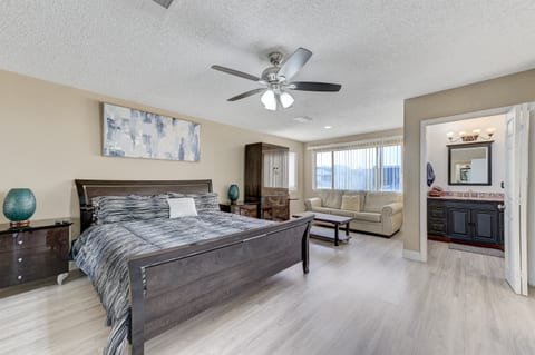 Master bedroom 2 has a California king bed, 60 inch smart tv, full bathroom 2, and a leather couch