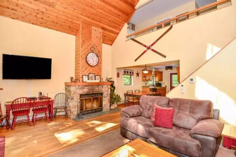 Main floor living area with HD TV and wood-burning fireplace - and lake views!