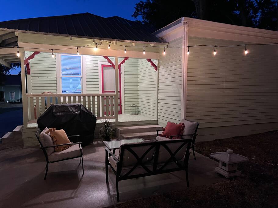 Enjoy a glass of wine or a cup of morning coffee on the back porch area.    Gas fire pit and a party lights complete the feel.