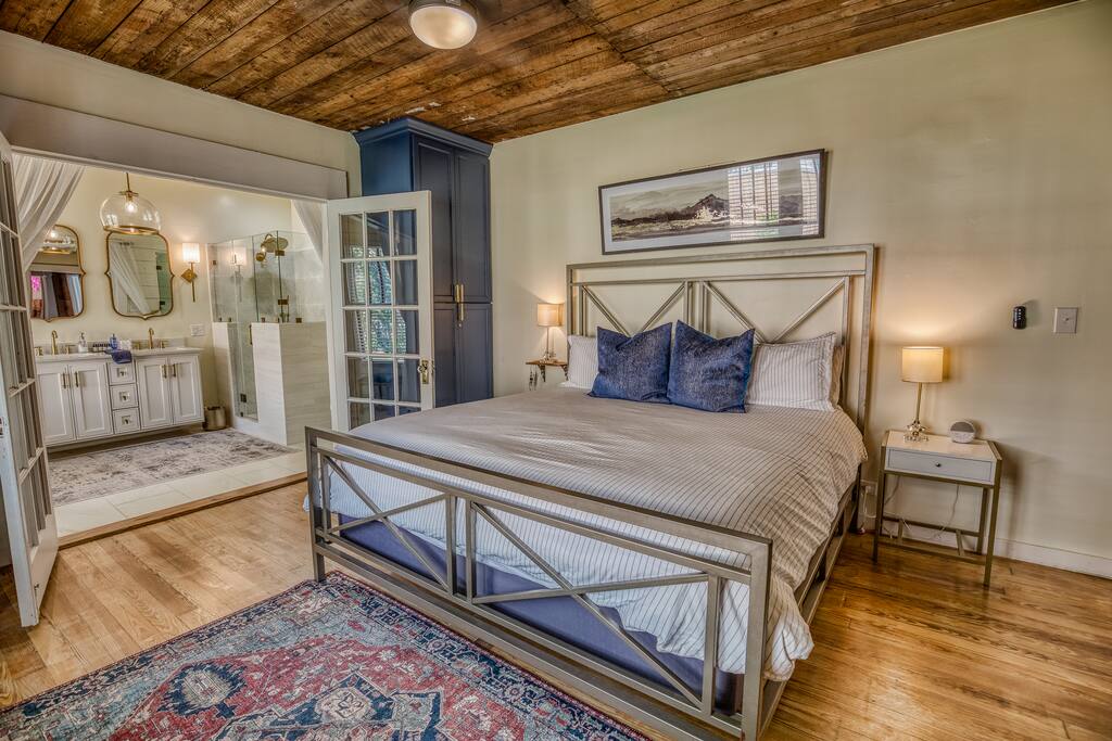 Large and very spacious primary bedroom graces the back of the property and opens to a large en suite bathroom.  Each bedroom has a white noise sound machine on the nightstand. Bedding by Nestwell.  