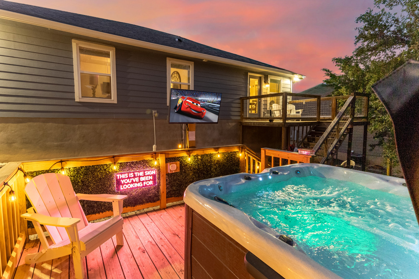 Private hot tub + outdoor TV — unwind under neon lights on your own deck retreat.