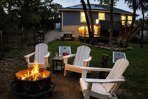 Gather around the fire pit under the stars — Adirondack seating, cornhole, and good company included