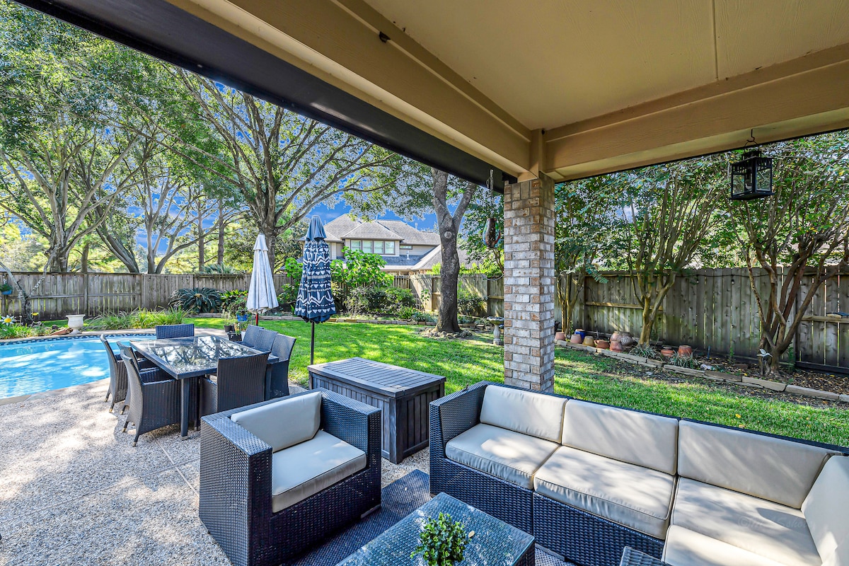 Covered patio with comfortable seating, perfect for relaxing outdoors.