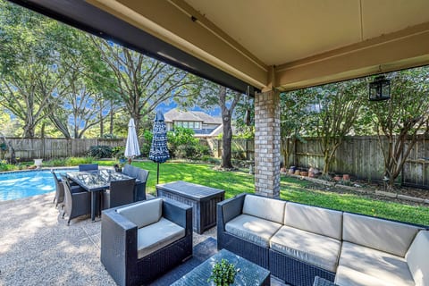 Covered patio with comfortable seating, perfect for relaxing outdoors.