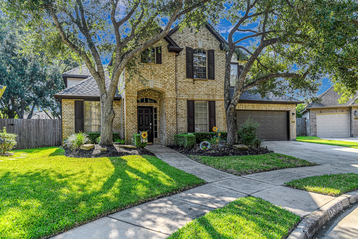 Charming exterior surrounded by mature trees.