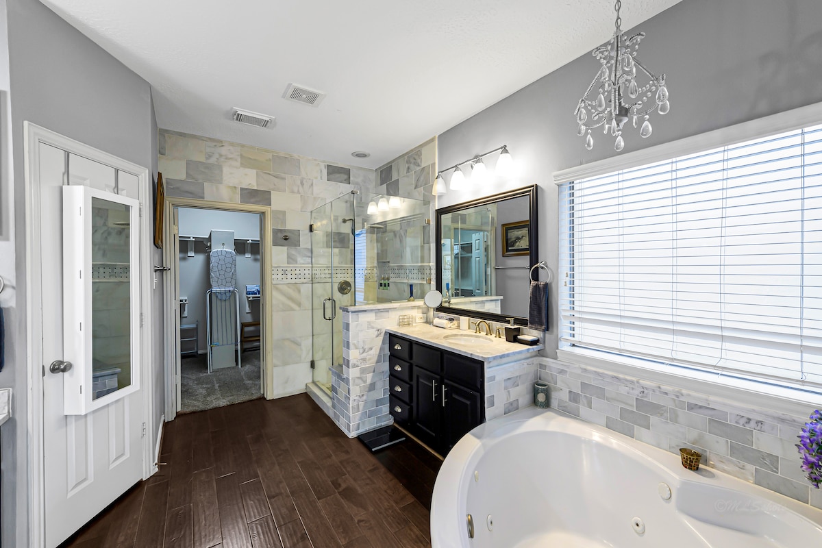 Spacious spa-like bathroom with walk-in shower and soaking tub.