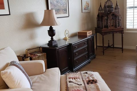 The bird cage in the corner is well over a half of a century old. The brass noodle cart was used by a vendor in Hong Kong about that long ago. The credenza houses games and puzzles now, but 50 years ago it held the good dishes.