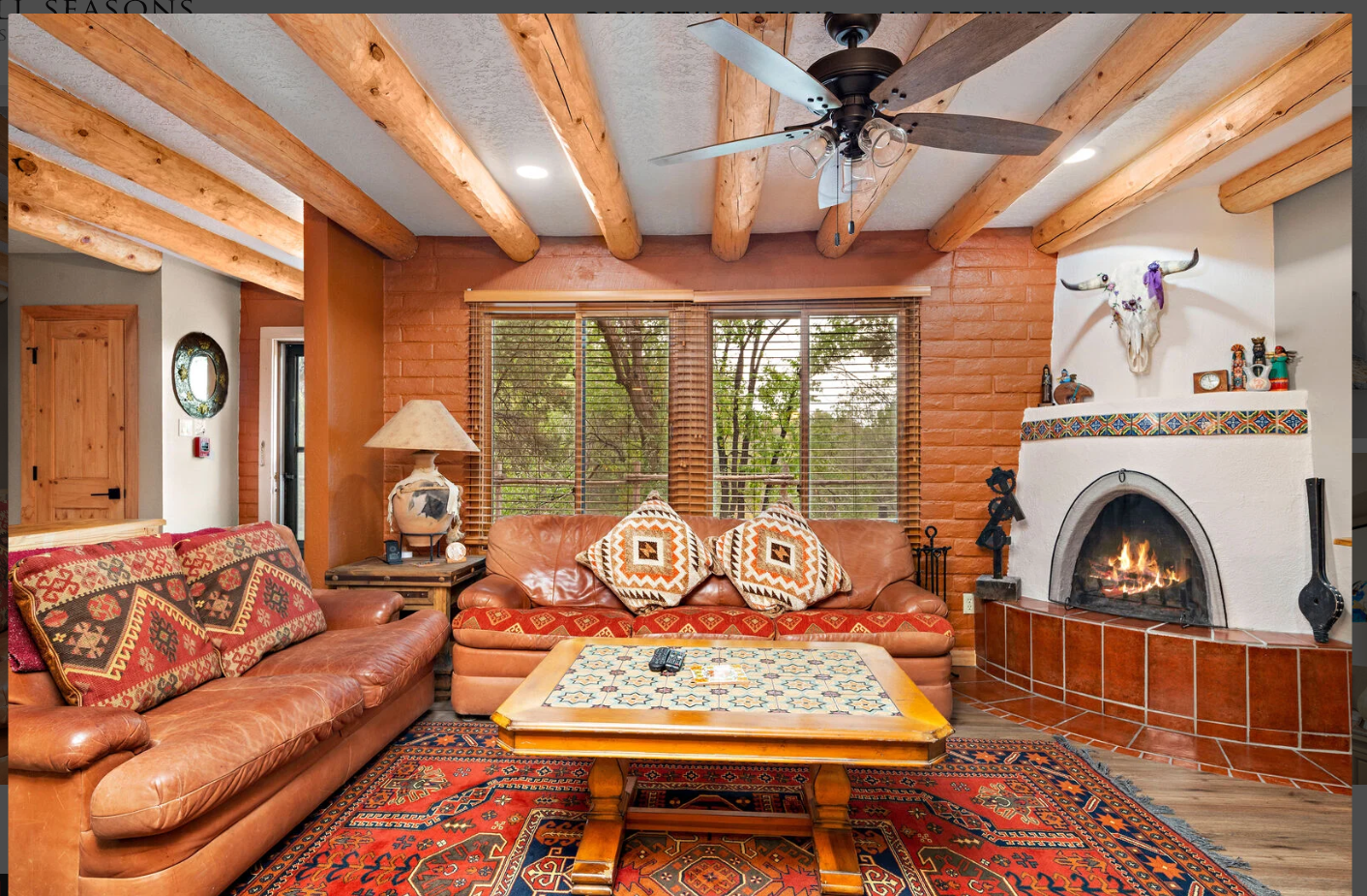 Stunning southwestern living area with a wood burning kiva provides plently of lounging space.