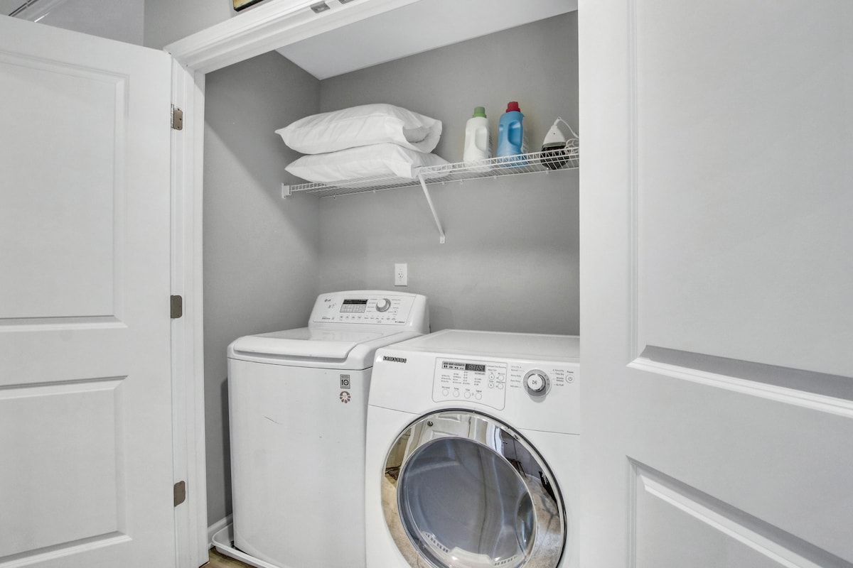 Laundry area with extra pillows, iron and iron board   laundry detergent 