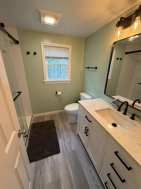 Second-floor bathroom with a full bathtub and fresh towels, perfect for relaxing soaks after a day exploring Cape Cod.