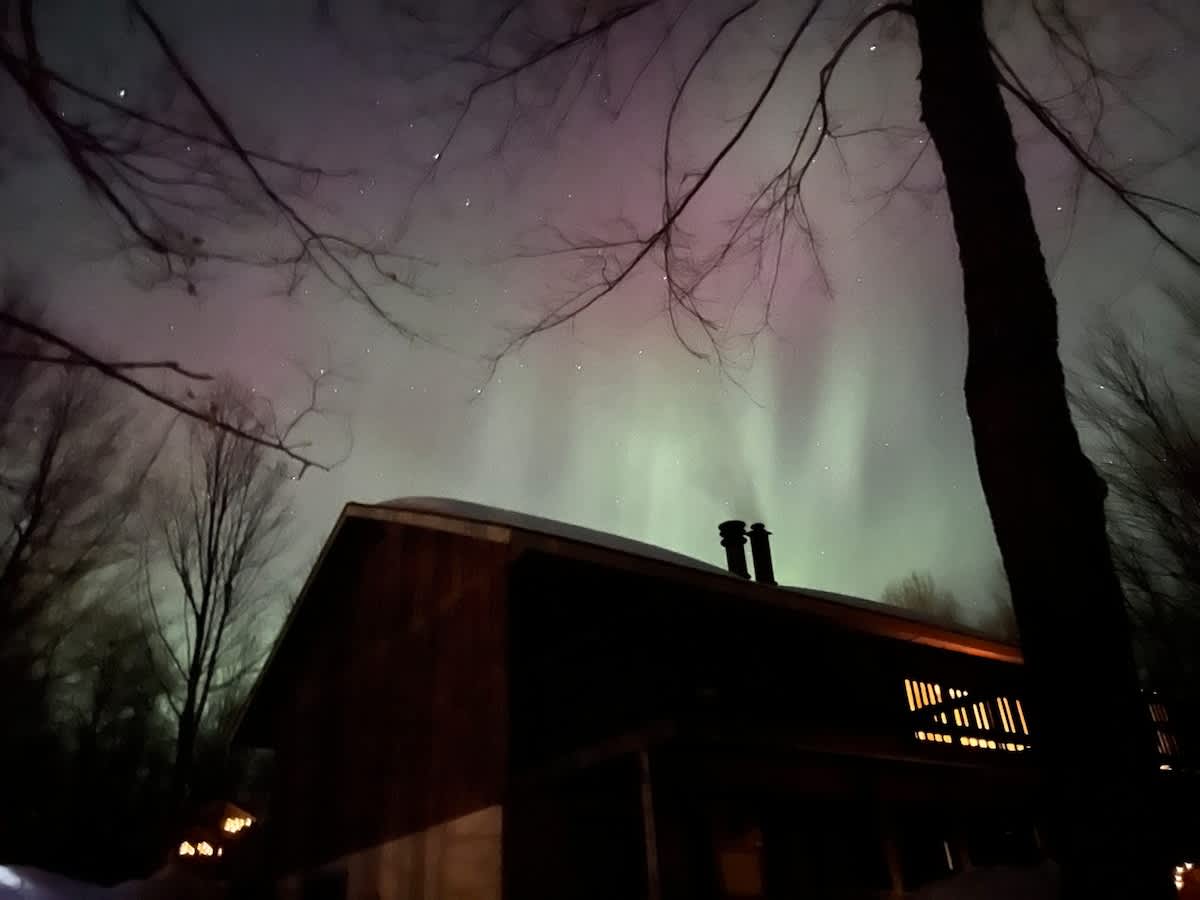 Aurora over Cabin Fevers — a magical night sky.