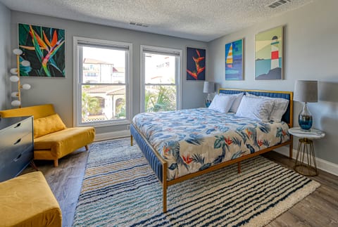 Master suite features a spacious king bed, futon chairs, massage chair, and kitchenette