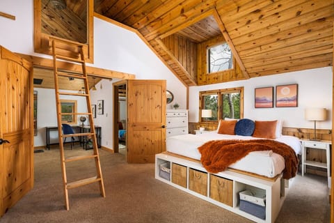 A rustic ladder leads up to a private sleeping loft, adding a touch of adventure to your stay in this uniquely designed space.