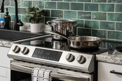 Whether you're heating up leftovers or making a full meal, the kitchen’s modern stove and cookware are ready when you are.