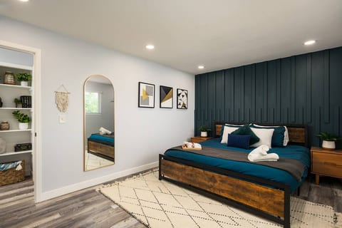 With soft lighting and a full-length mirror, this corner of the bedroom gives you space to spread out and feel at home.
