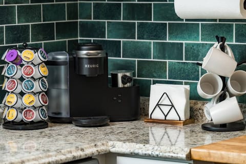 Start your mornings right with a variety of coffee pod options and mugs, all tucked into a handy corner by the kitchen.